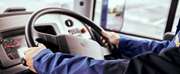 driver hands on steering wheel of megabus coach