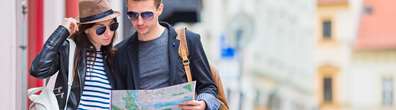 A couple looking at a map in a city